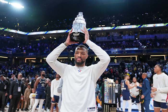 Damian Lillard holds up the MVP trophy after the NBA All-Star Game.